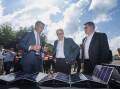 Anthony Albanese, centre, announced a plan to spark more solar projects. Picture by Marina Neil