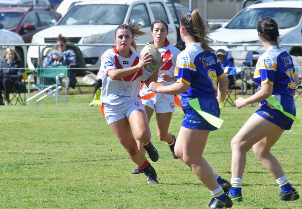 Manildra halfback Molly Hoswell looks for space in the Condobolin Rams' defensive line. Picture by Carla Freedman
