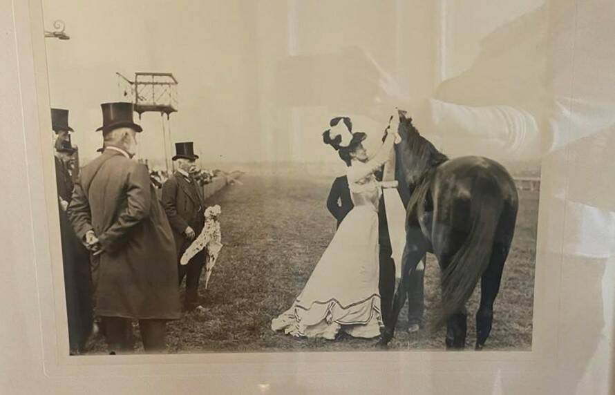Merriwee won the Melbourne Cup in 1899 and there's Miss Traill's grandfather watching as it's being sashed by the governor's wife.