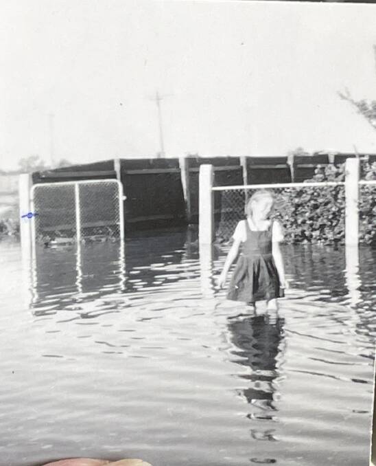 A picture of Marie Daymond as a child, playing in the Forbes floodwater. Picture by Alise McIntosh