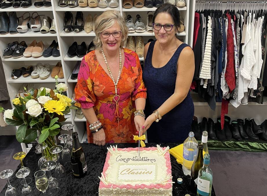 Recycled Classics owner Helen Morgan and assistant Debora Thomas celebrated the store expansion with cake and bubbles. Picture by Alise McIntosh