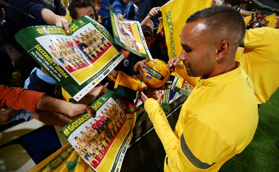 Archie Thompson, a former Bathurst High student, signs autographs for fans in Sydney back in 2013. Picture by Getty Images/Matt King-Stringer
