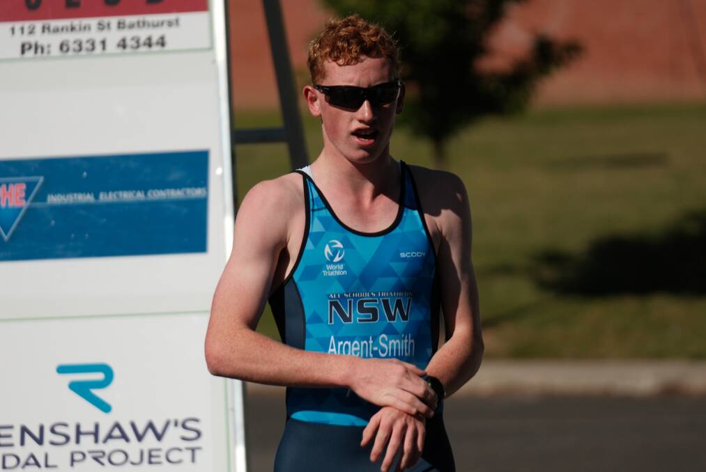 Angus Argent-Smith crosses the finish line first at Sunday's long course triathlon in Bathurst. Picture by James Arrow