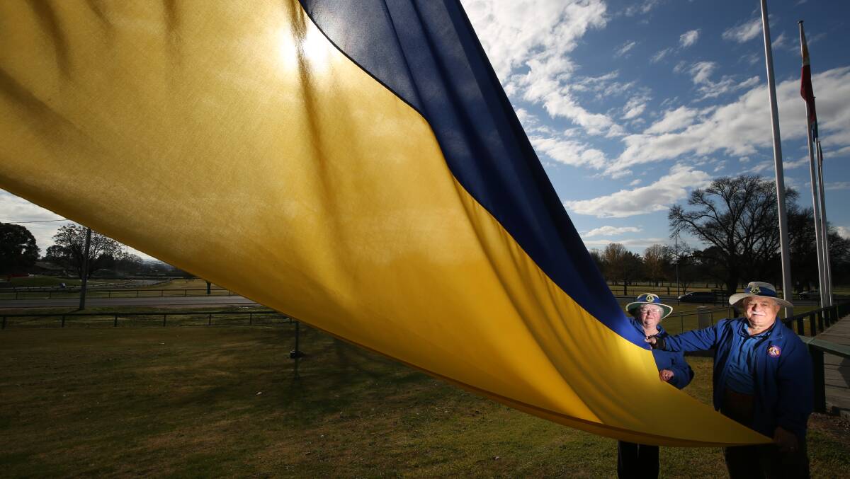 Judy and Dominic Chircop with the Ukrainian flag at the Evans Bridge flagpoles last year. Picture by Phil Blatch.