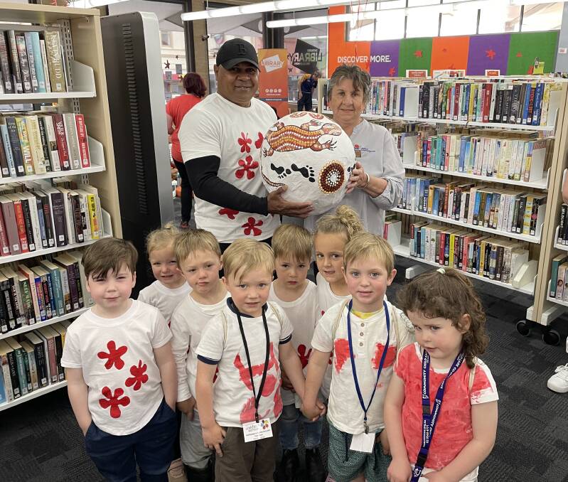Bubba Kennedy and Aunty Shirl Scott with the goanna egg that featured at an event at Bathurst Library this week and some of the children who attended.