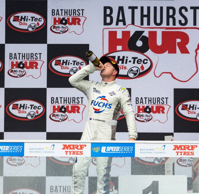 Brad Schumacher enjoys a drink of champagne on the Bathurst podium. Picture supplied