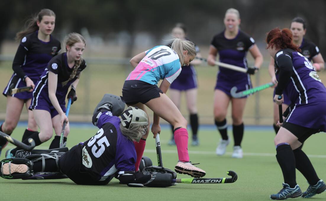 Bathurst City skipper Emily Thompson tries to find a way past Lithgow goalkeeper Brenna Croker. Picture by Phil Blatch