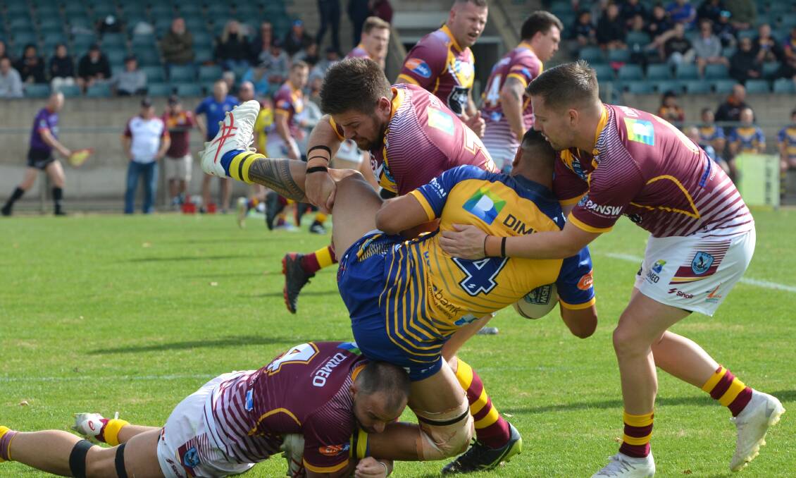 Bathurst league talent James Woolmington works with his NSW Country team-mates to stop City centre Peter Pakoti. Picture by Anya Whitelaw