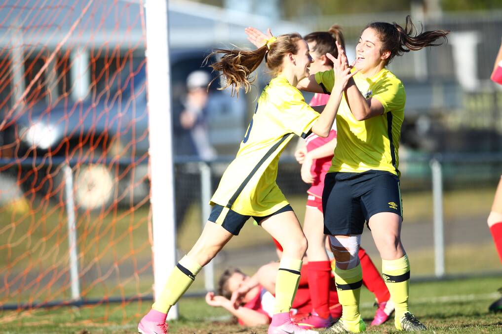Cushla Rue (left) celebrates scoring at goal at Proctor Park six years ago when she played for Western NSW. Picture by Phil Blatch