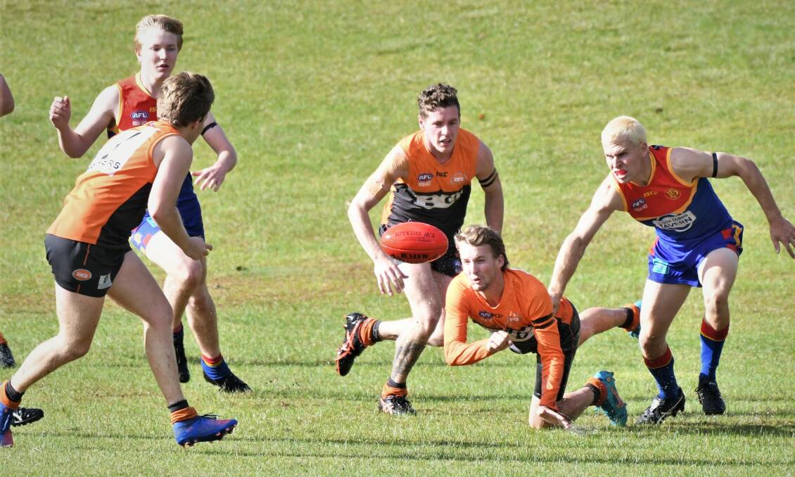 HARD DAY: Brody Taylor hand-balls off the ground during the Giants' round one clash with Dubbo. Saturday's re-match in Dubbo was dominated by the Demons. Photo: CHRIS SEABROOK