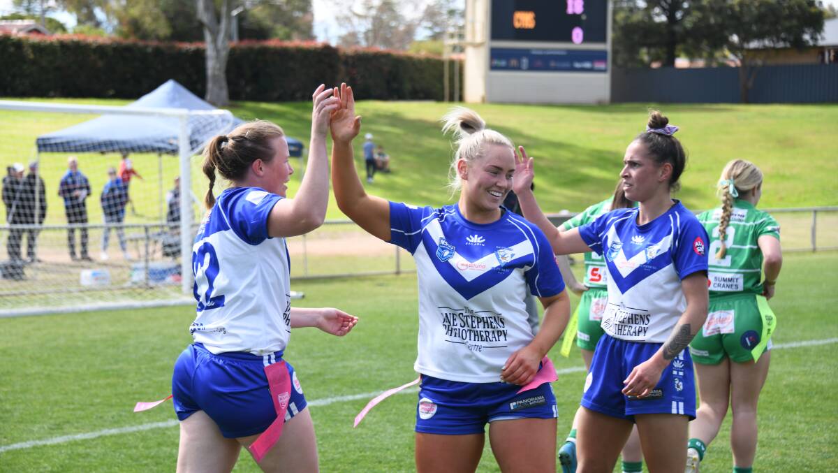 Sarah White, Maddy Boyce and Erin Naden celebrate a Saints try in Sunday's win over Dubbo CYMS. Picture by Amy McIntyre