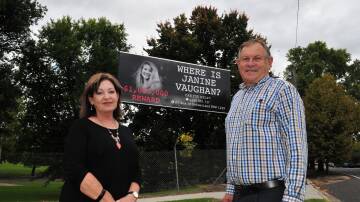 Rhonda Griffin and Peter Rogers standing near the Janine Vaughan billboard in 2023, before her image was covered. The billboard has since been handed back to the community and will now be used to promote community events.