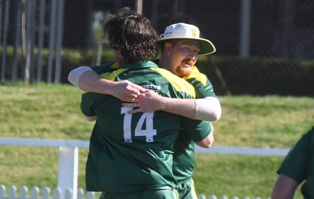 Rory Daburger and Ben Orme embrace after the latter picked up a wicket in CYMS' match against City Colts. Picture by Jude Keogh 