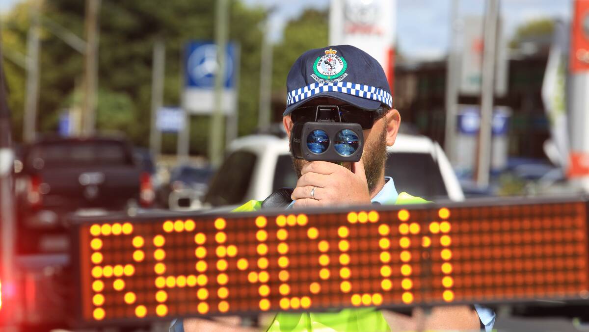 A senior constable breath-testing and checking speed on Escort Way. File picture