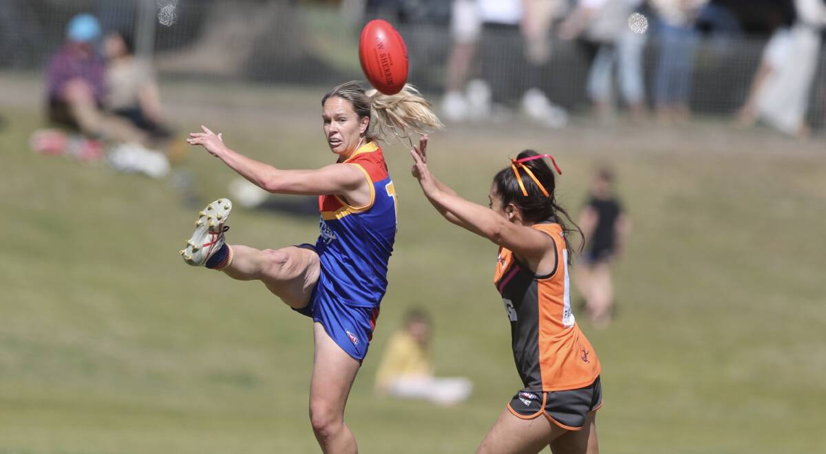 Emily Warner sends the ball forward for the Demons in Saturday's win. Picture by Phil Blatch.