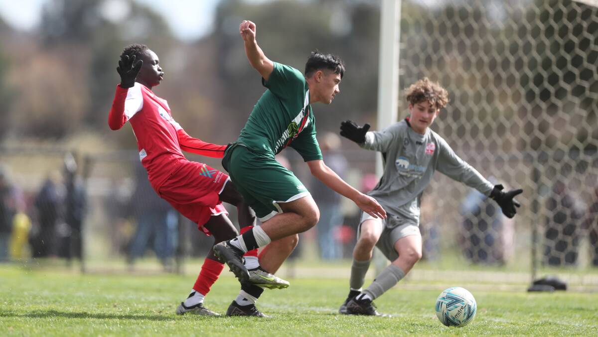 Western under 15s striker Raphael Ortiz (centre) lines up a shot against Nepean. Picture by Phil Blatch