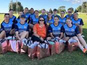 Alissa West (centre) with the Macquarie Raidettes and the donated dignity bags. Picture supplied