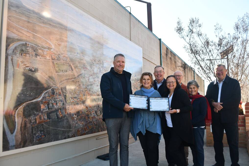 Peter Wright and Lisa Mallon of Central Commercial Printers receive the heritage award from councillor Marg Hogan (centre) alongside representatives of the Bathurst branch of the National Trust, Wayne Feebrey, Geoff Fry, Libby Loneragan and Iain McPherson. Picture by Rachel Chamberlain