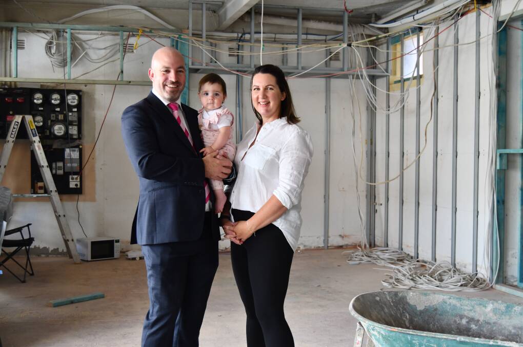 Mitchell and Sheridan Bestwick with their daughter, Ivy, standing in what will become the new office for their real estate agency. Picture by Rachel Chamberlain