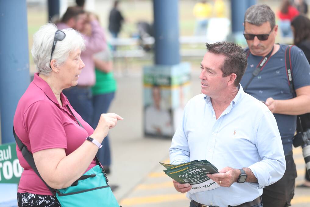 Elizabeth Stoneman talking to incumbent Paul Toole outside the polling booth. Picture by Phil Blatch