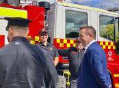 Member for Bathurst Paul Toole speaking with a group of firefighters. Picture supplied