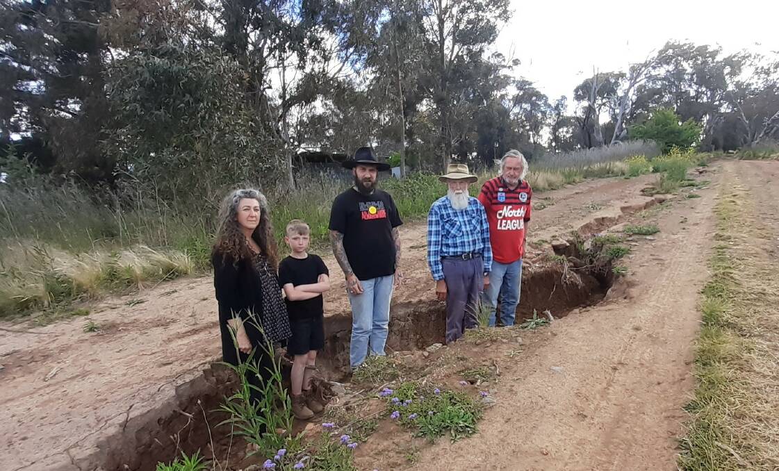 Wattle Flat residents showing the extent of the damage to the Crown Road they use to access their properties. Picture by Rosie Mueller