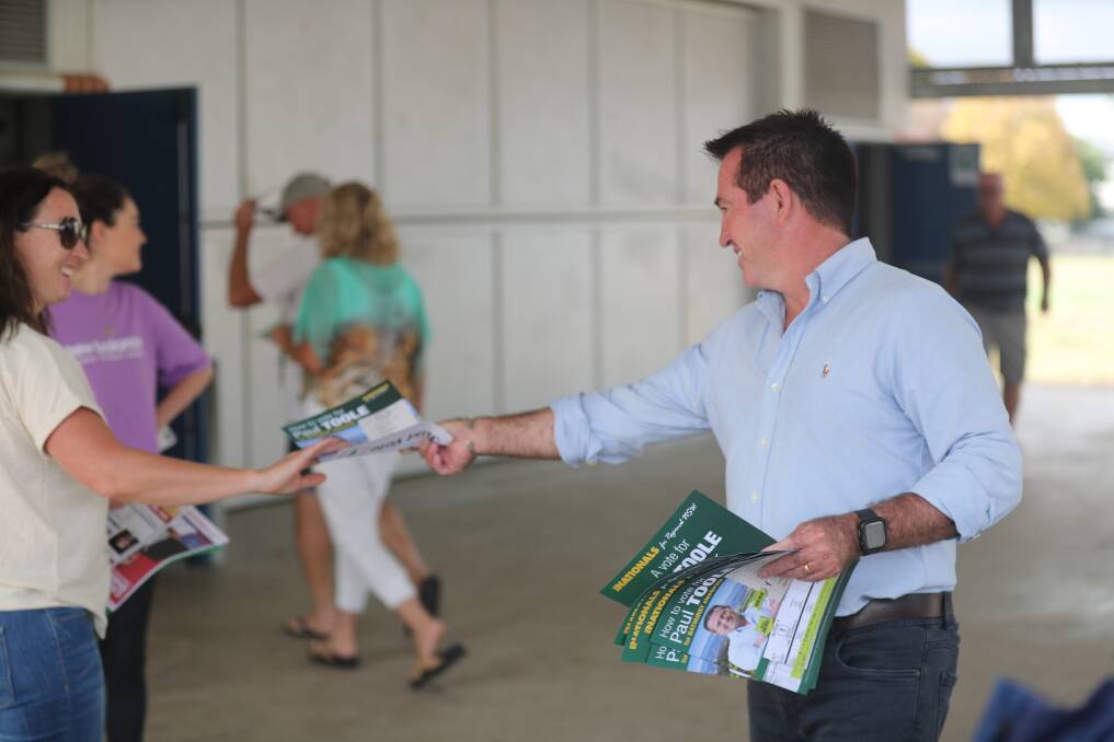 Paul Toole handing out his election material at Kelso Public School. Picture by Phil Blatch