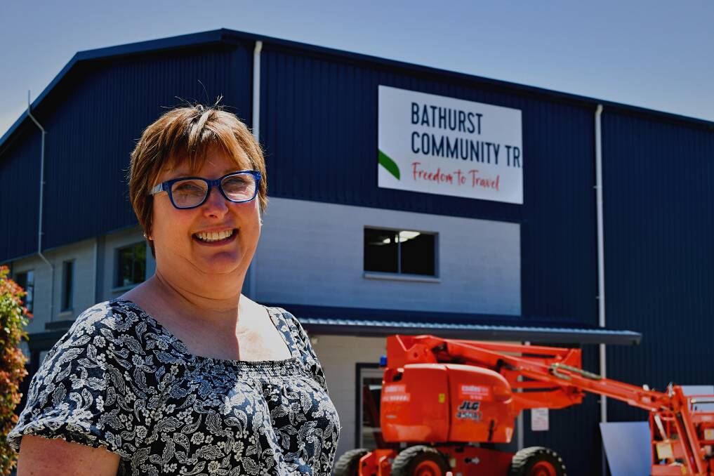 Kathryn Akre out the front of the new Bathurst Community Transport premises, which was in the process of having its sign fitted. Picture by Rachel Chamberlain