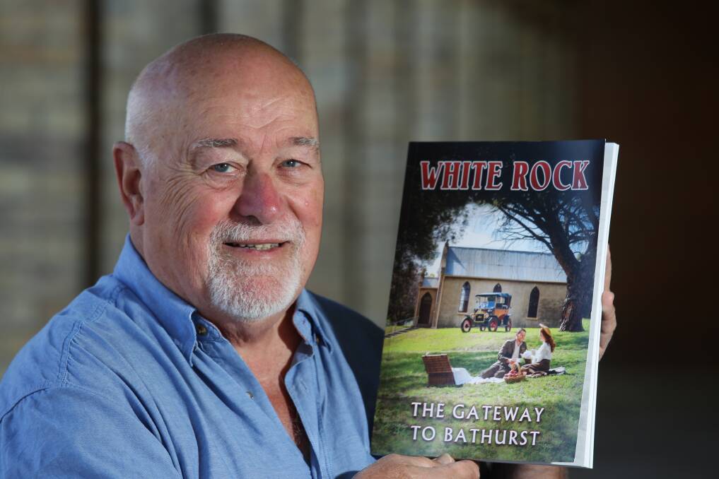 VERY HAPPY: John Down, the coordinator of White Rock: The gateway to Bathurst, , pictured with the book, which is in its third print run. Photo: PHIL BLATCH 041817pbrock5