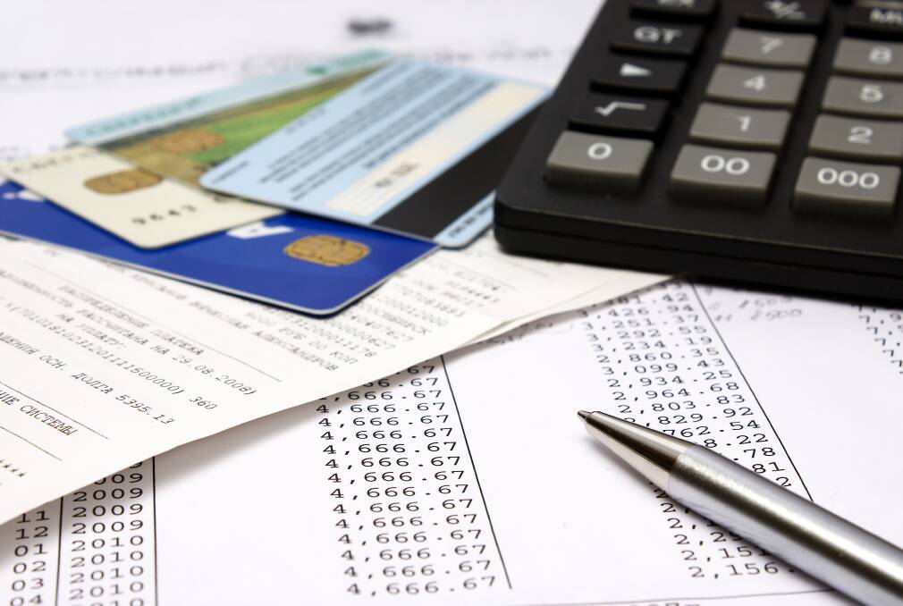 Credit cards, bills and a calculator piled on top of each other. Picture file