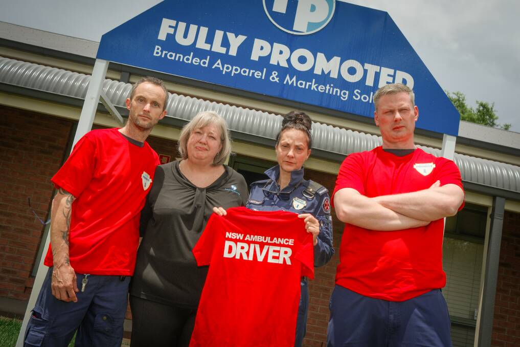 Paramedics Phillip Livingstone, Claire Green and Sean Mannix with Fully Promoted's Liz Luisi (second from left), holding their new red shirts. Picture by James Arrow