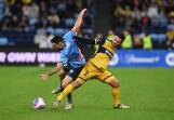 Mikael Doka, seen tussling with Sydney's Anthony Caceres, starred in the Mariners' win. (Dean Lewins/AAP PHOTOS)