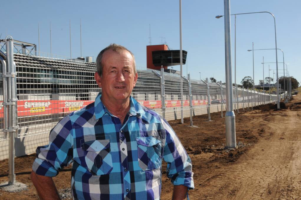 SAFETY FIRST: Councillor Bobby Bourke inspects the new mesh fencing erected along Pit Straight. Photo: ZENIO LAPKA 083013zfence4